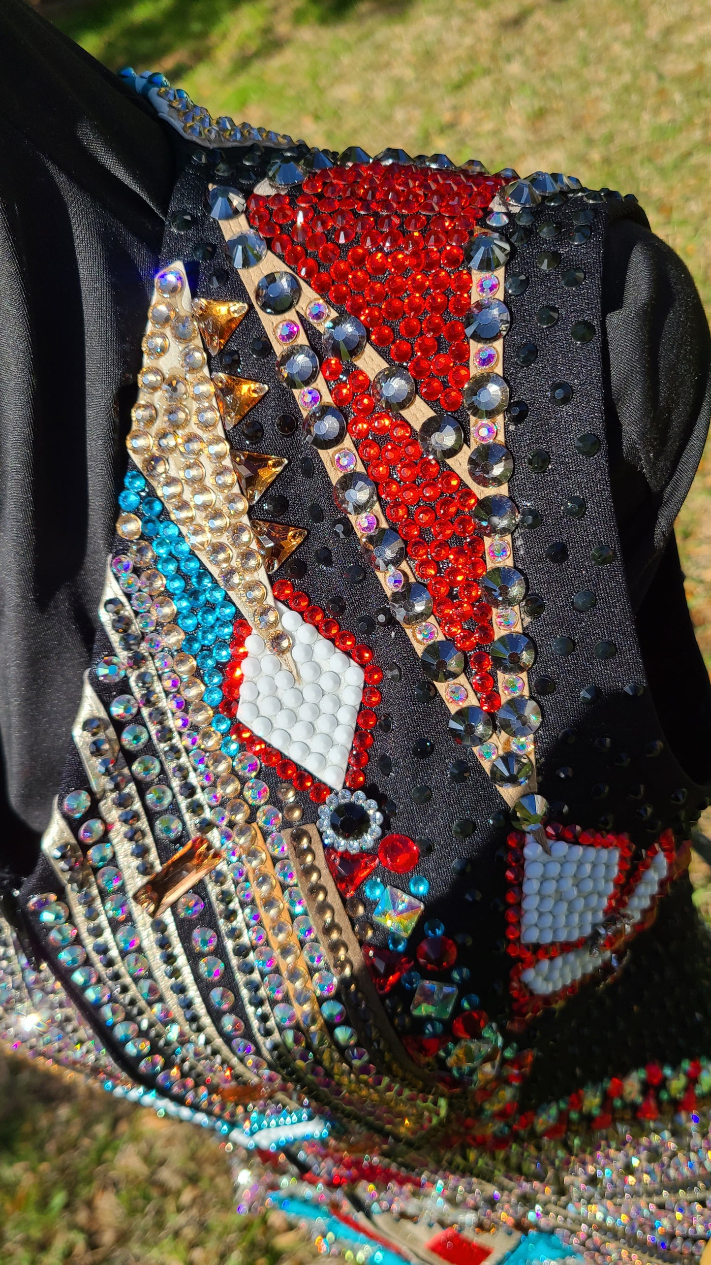 Size small Black Vest, with red, white, aqua and gold
