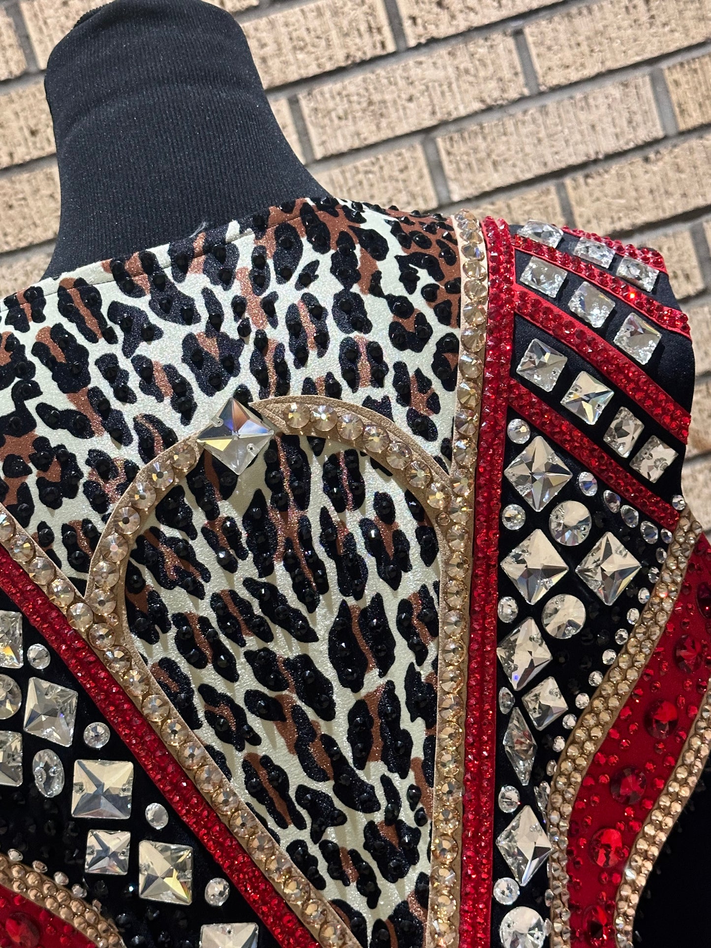 Large vest with black, gold and red with clear crystals and leopard print