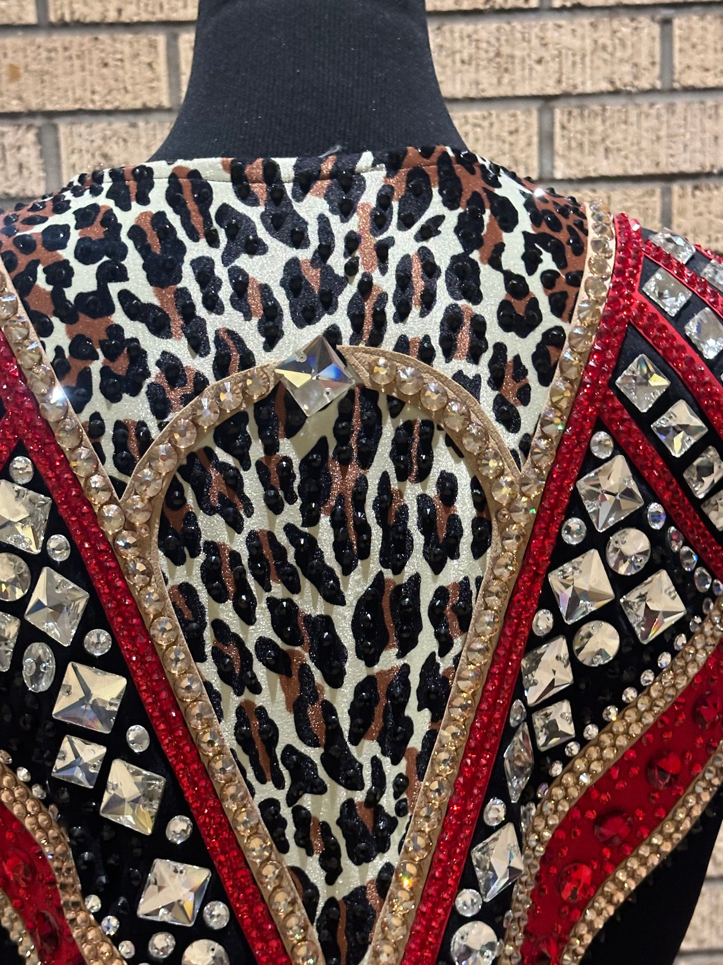 Large vest with black, gold and red with clear crystals and leopard print