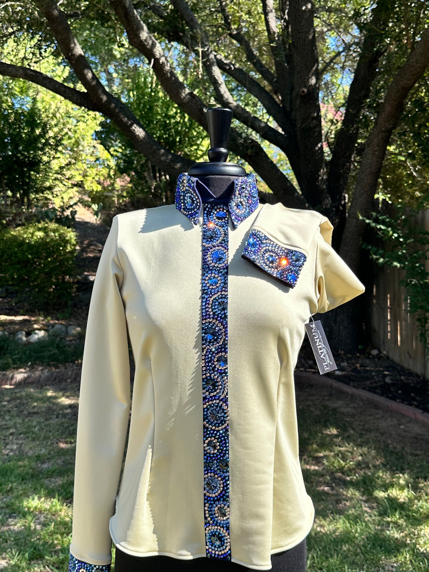 Size medium day shirt gold back zip with navy designs.