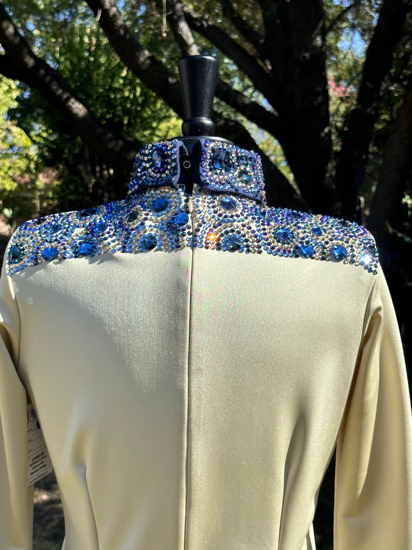 Size medium day shirt gold back zip with navy designs.