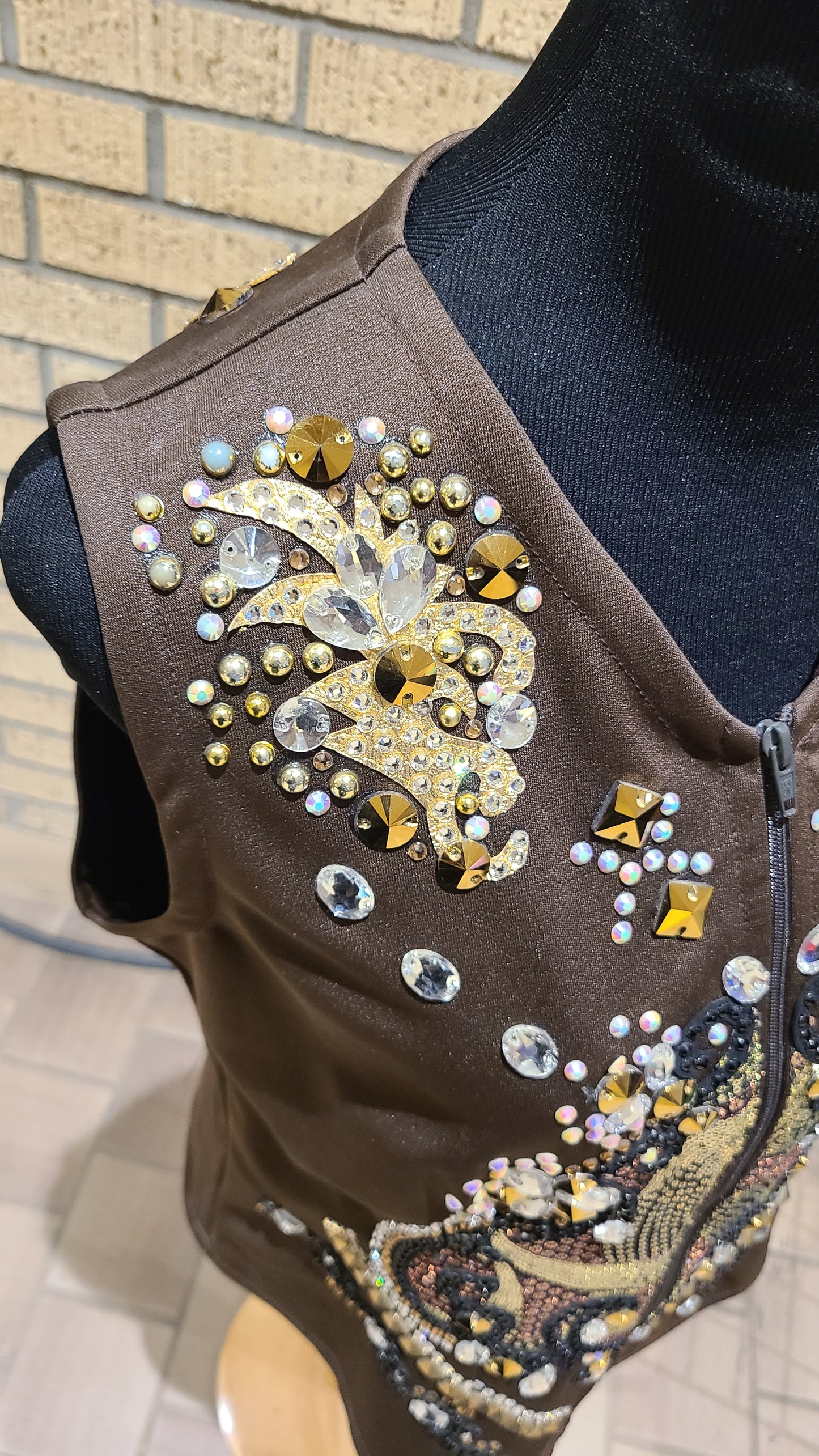 Size medium chocolate vest with black, gold and clear design