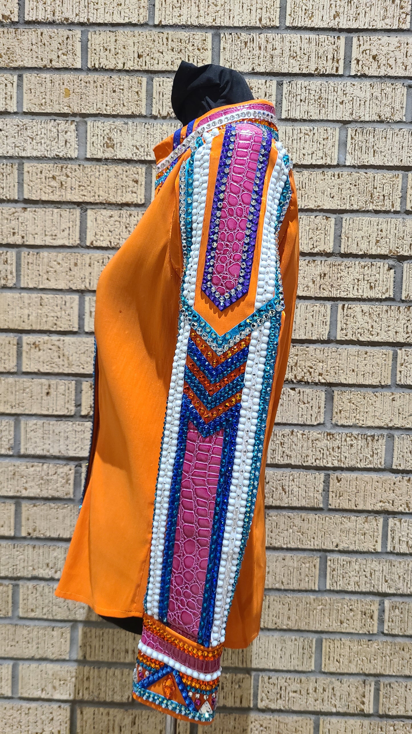 Size medium stretch orange taffeta with blue, turquoise, purple design. White and silver accents